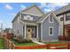 Charming two-story home showcasing blue siding, a welcoming yellow door, and a quaint front porch at 357 Parkway Ave, Indianapolis, IN 46225