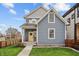 Charming two-story home with blue siding, a yellow front door, and a well-maintained lawn at 357 Parkway Ave, Indianapolis, IN 46225