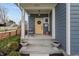 Inviting front porch with a yellow door, potted plants, and a seating area for relaxing outdoors at 357 Parkway Ave, Indianapolis, IN 46225