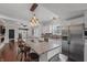Bright, renovated kitchen with granite countertops, stainless steel appliances, and a central island with bar seating at 357 Parkway Ave, Indianapolis, IN 46225