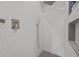 Shower showcasing clean white hexagon tile, a modern shower head, and convenient storage niche at 357 Parkway Ave, Indianapolis, IN 46225