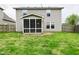 This backyard has a screened in porch, mature green grass, and a wood fence at 3930 Towhees Dr, Indianapolis, IN 46237