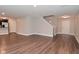 Finished basement with wood floors, access to the staircase and exterior door, and a partial kitchen at 3930 Towhees Dr, Indianapolis, IN 46237