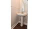 Bathroom featuring pedestal sink, mirror, and modern fixtures at 3930 Towhees Dr, Indianapolis, IN 46237