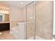 Modern bathroom featuring tile surround tub, shower with glass door, and single sink at 3930 Towhees Dr, Indianapolis, IN 46237