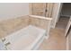Bathroom featuring soaking tub with tile surround and floors with new hardware at 3930 Towhees Dr, Indianapolis, IN 46237