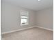 Bright bedroom features neutral walls, carpet flooring, and a window with blinds at 3930 Towhees Dr, Indianapolis, IN 46237