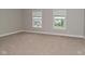 Spacious bedroom featuring neutral walls, carpet flooring and natural light from dual windows at 3930 Towhees Dr, Indianapolis, IN 46237