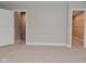 Bedroom features neutral walls, carpet, walk-in closet, and a white paneled door at 3930 Towhees Dr, Indianapolis, IN 46237