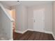Entryway features wood floors, stairs, and a view of a powder room at 3930 Towhees Dr, Indianapolis, IN 46237