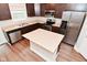 Kitchen with stainless steel appliances, granite countertops, island, and dark wood cabinets at 3930 Towhees Dr, Indianapolis, IN 46237