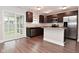 Eat-in kitchen with dark cabinets, stainless steel appliances, and a sliding glass door at 3930 Towhees Dr, Indianapolis, IN 46237