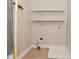 Laundry room with utility connections, shelving, and tiled flooring at 3930 Towhees Dr, Indianapolis, IN 46237