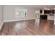 Open-concept living room with hardwood floors and a view of the kitchen at 3930 Towhees Dr, Indianapolis, IN 46237