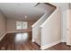 Bright living room features wood floors, a staircase, and large windows for natural light at 3930 Towhees Dr, Indianapolis, IN 46237