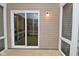 This patio area has a sliding glass door and an outdoor light at 3930 Towhees Dr, Indianapolis, IN 46237