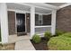 Charming front porch with brick accents, white columns, and neatly trimmed shrubs at 3930 Towhees Dr, Indianapolis, IN 46237
