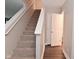 Carpeted staircase with white railing leads to upper level at 3930 Towhees Dr, Indianapolis, IN 46237