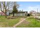 Backyard featuring a sunroom and landscaping at 415 S East St, Plainfield, IN 46168