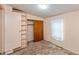 Bedroom features carpet, closet, built-in shelves, and window with curtain at 415 S East St, Plainfield, IN 46168