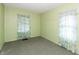Bedroom with carpet, two windows with curtains, and green painted walls at 415 S East St, Plainfield, IN 46168