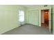 Bedroom with green painted walls, carpet, closet, and window with curtain at 415 S East St, Plainfield, IN 46168