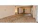 Open-concept living room with neutral walls, carpet flooring, and ample natural light at 415 S East St, Plainfield, IN 46168