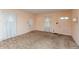 Spacious living room featuring multiple windows, carpet flooring, and neutral walls at 415 S East St, Plainfield, IN 46168