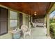 Inviting covered front porch featuring a wood ceiling, swing, and seating area at 415 S East St, Plainfield, IN 46168