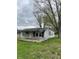 Charming single-story home featuring a covered front porch and mature trees, perfect for quiet evenings at 4206 Clark St, Anderson, IN 46013
