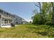 Large backyard with a patio, grill, and a lush lawn extending to the tree line at 4333 Ironclad Dr, Bargersville, IN 46106