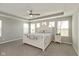 Spacious bedroom with tray ceiling, fan, carpet and large bed with decorative pillows at 4333 Ironclad Dr, Bargersville, IN 46106