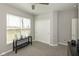 Minimalist bedroom with a window, closet, and dark colored furniture in a neutral color palette at 4333 Ironclad Dr, Bargersville, IN 46106
