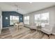 A dining room features a neutral palette, wood floors, bright windows and two accent chairs at 4333 Ironclad Dr, Bargersville, IN 46106