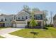 Inviting two-story home featuring a lush lawn, three-car garage and stone accents at 4333 Ironclad Dr, Bargersville, IN 46106