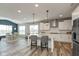 Open kitchen featuring an island with pendant lights and gray bar stools and a stainless steel refrigerator at 4333 Ironclad Dr, Bargersville, IN 46106