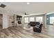 Open concept living room boasts a stone fireplace, large sectional and neutral color palette at 4333 Ironclad Dr, Bargersville, IN 46106
