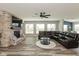 Spacious living room featuring a stone fireplace, a large sectional and wood flooring at 4333 Ironclad Dr, Bargersville, IN 46106