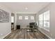 Bright office space featuring wood floors, three windows, and a modern workstation at 4333 Ironclad Dr, Bargersville, IN 46106