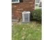 Exterior air conditioning unit positioned next to the brick wall of the home at 5209 S Bancroft St, Indianapolis, IN 46237
