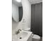 Bathroom featuring vanity, toilet, mirror, and shower with a gray curtain at 5209 S Bancroft St, Indianapolis, IN 46237