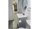 Bathroom featuring vanity, toilet, modern fixtures, and view of the kitchen area at 5209 S Bancroft St, Indianapolis, IN 46237