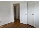 A well-lit bedroom featuring hardwood flooring and a convenient closet for storage at 5209 S Bancroft St, Indianapolis, IN 46237