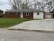 Charming brick and siding home featuring a well-maintained front yard and a detached garage at 5209 S Bancroft St, Indianapolis, IN 46237