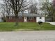 Charming single-story home with brick and siding, complemented by a well-maintained lawn at 5209 S Bancroft St, Indianapolis, IN 46237
