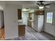 Well-equipped kitchen featuring laminate floors, modern appliances, and convenient access to the outdoors at 5209 S Bancroft St, Indianapolis, IN 46237