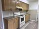 Well-appointed kitchen featuring laminate floors, modern appliances, and abundant cabinet space at 5209 S Bancroft St, Indianapolis, IN 46237