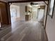 Open-concept kitchen features wood cabinets, appliances, gray countertops, and a window overlooking the living area at 5209 S Bancroft St, Indianapolis, IN 46237