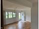 Bright living room showcasing hardwood floors and a large window offering ample natural light at 5209 S Bancroft St, Indianapolis, IN 46237