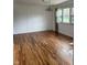 Spacious living room featuring wood floors and modern lighting fixtures at 5209 S Bancroft St, Indianapolis, IN 46237